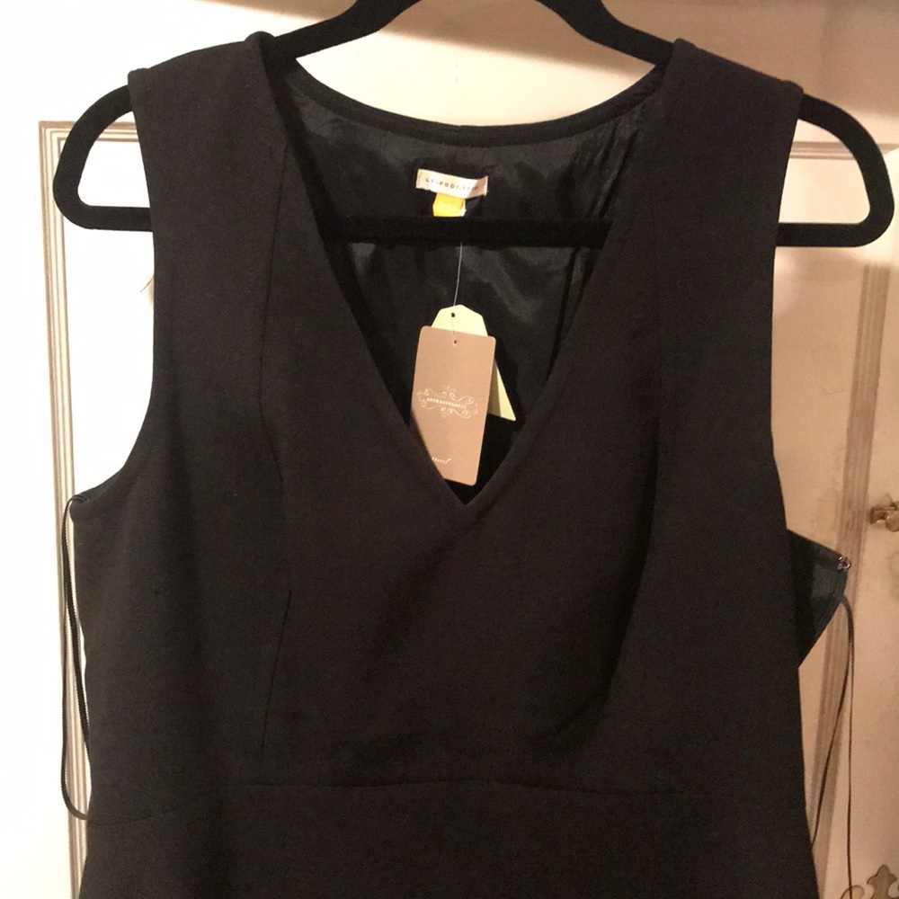 Anthropologie Black peplum high low top